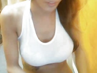 Shemale in a sports bra strokes her huge white cock