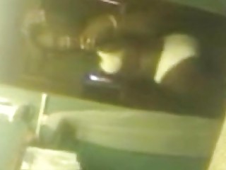 Black shemale in a bikini records herself in a mirror